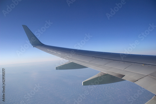 Airplane wing in the sky. View from a great height.