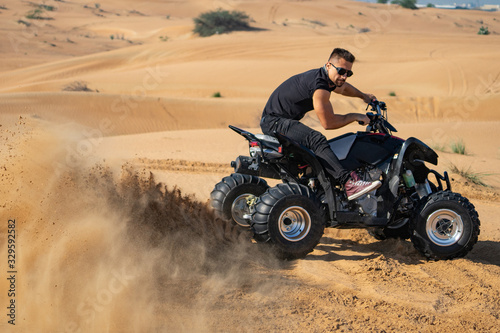 Muscular Man Riding Atv In the Desert