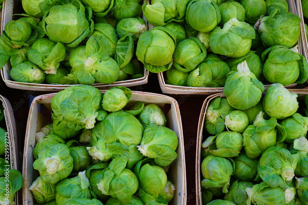 Containers of fresh organic green Brussels sprouts at the farmers market Containers of fresh organic green Brussels sprouts at the farmers market