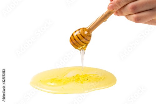 Dipper with honey in woman hand.