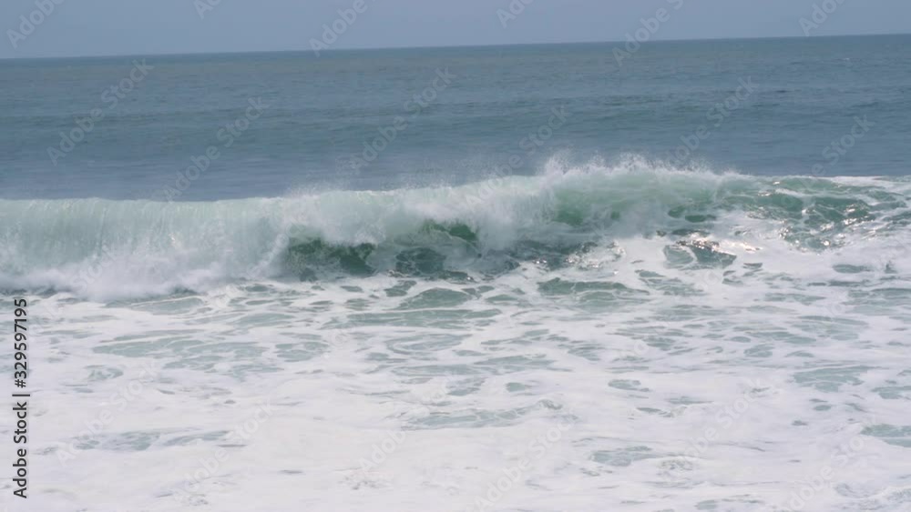 Crashing ocean wave on beach shore in slow motion Crashing ocean wave on beach shore in slow motion