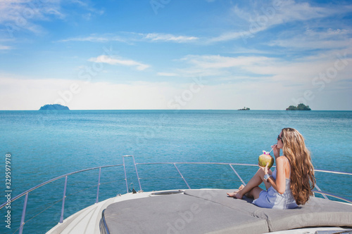 luxury travel, woman relaxing on luxurious boat and drinking coconut, vip sea cruise