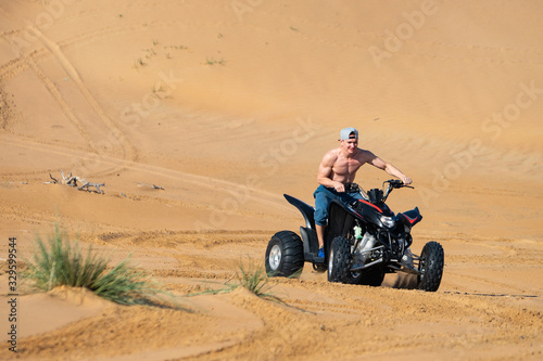 Muscular Man topless Riding Atv In the Desert