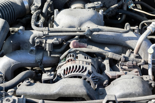 Wallpaper Mural Dusty details of a flat-four (boxer) car engine compartment under the open hood. Alternator and intake manifold. Closeup view on a sunny day Torontodigital.ca