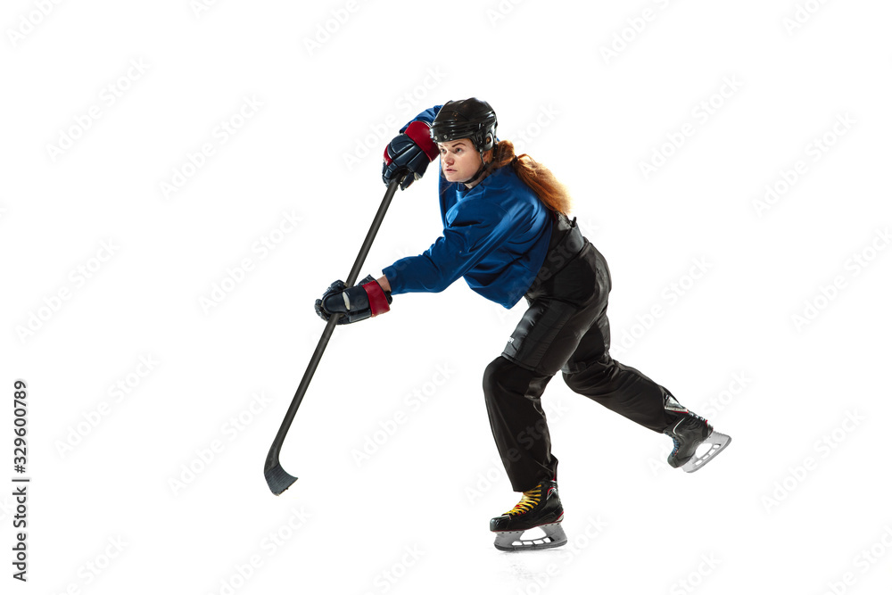 Young female hockey player with the stick on ice court and white background. Sportswoman wearing equipment and helmet training. Concept of sport, healthy lifestyle, motion, action, human emotions. Young female hockey player with the stick on ice court and white background. Sportswoman wearing equipment and helmet training. Concept of sport, healthy lifestyle, motion, action, human emotions.