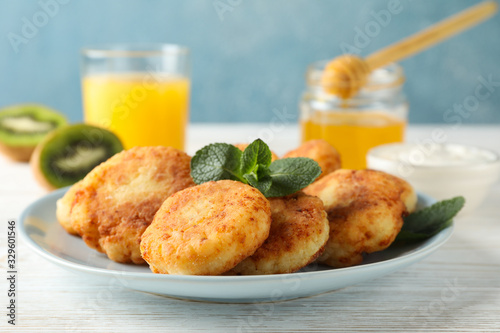 Breakfast of cheese pancakes on wooden background, close up