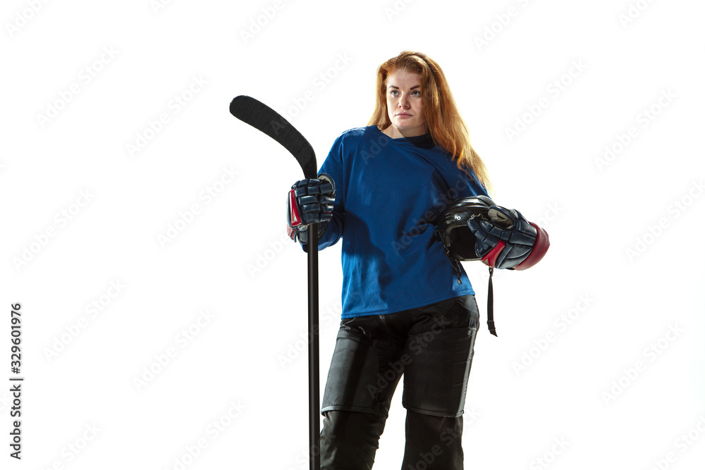 Young female hockey player with the stick on ice court and white background. Sportswoman wearing equipment and helmet posing. Concept of sport, healthy lifestyle, motion, action, human emotions. Young female hockey player with the stick on ice court and white background. Sportswoman wearing equipment and helmet posing. Concept of sport, healthy lifestyle, motion, action, human emotions.