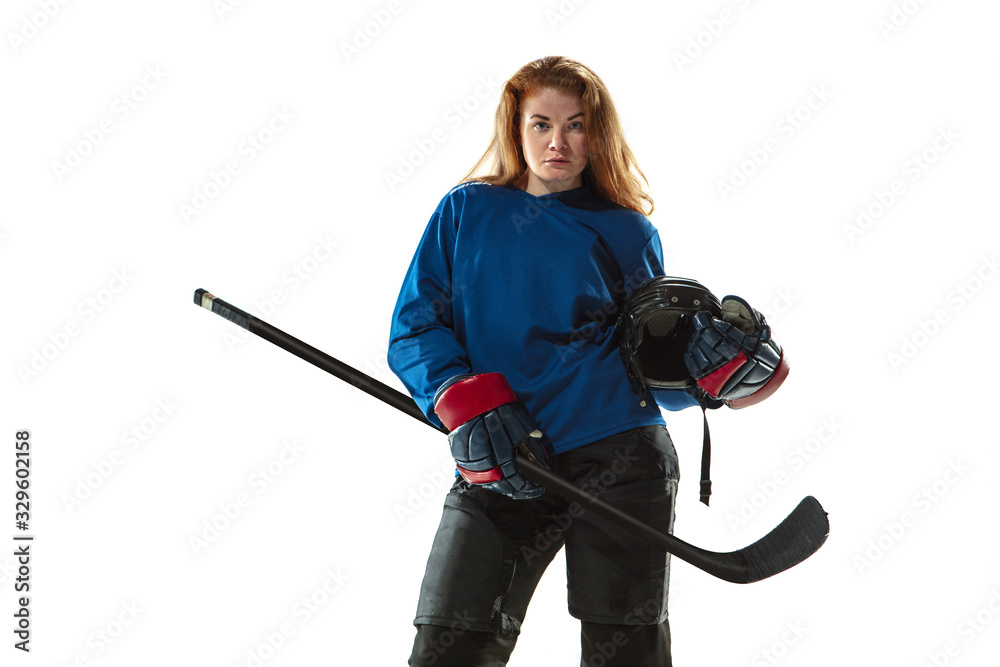 Young female hockey player with the stick on ice court and white background. Sportswoman wearing equipment and helmet posing. Concept of sport, healthy lifestyle, motion, action, human emotions. Young female hockey player with the stick on ice court and white background. Sportswoman wearing equipment and helmet posing. Concept of sport, healthy lifestyle, motion, action, human emotions.