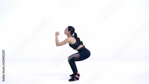 profile of sportswoman doing squat exercise on white photo
