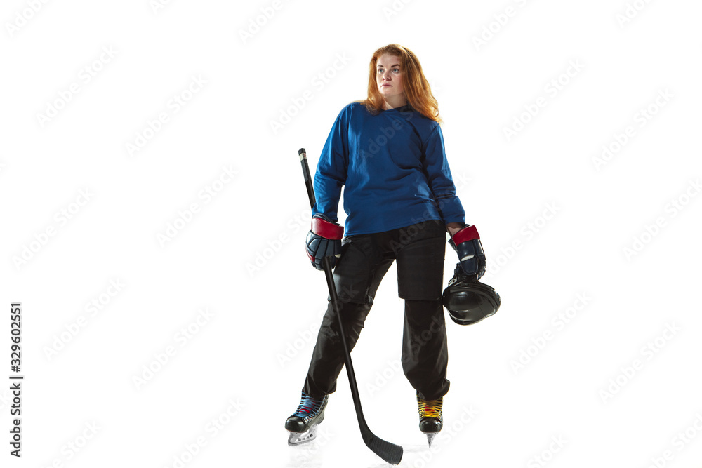 Young female hockey player with the stick on ice court and white background. Sportswoman wearing equipment and helmet posing. Concept of sport, healthy lifestyle, motion, action, human emotions. Young female hockey player with the stick on ice court and white background. Sportswoman wearing equipment and helmet posing. Concept of sport, healthy lifestyle, motion, action, human emotions.