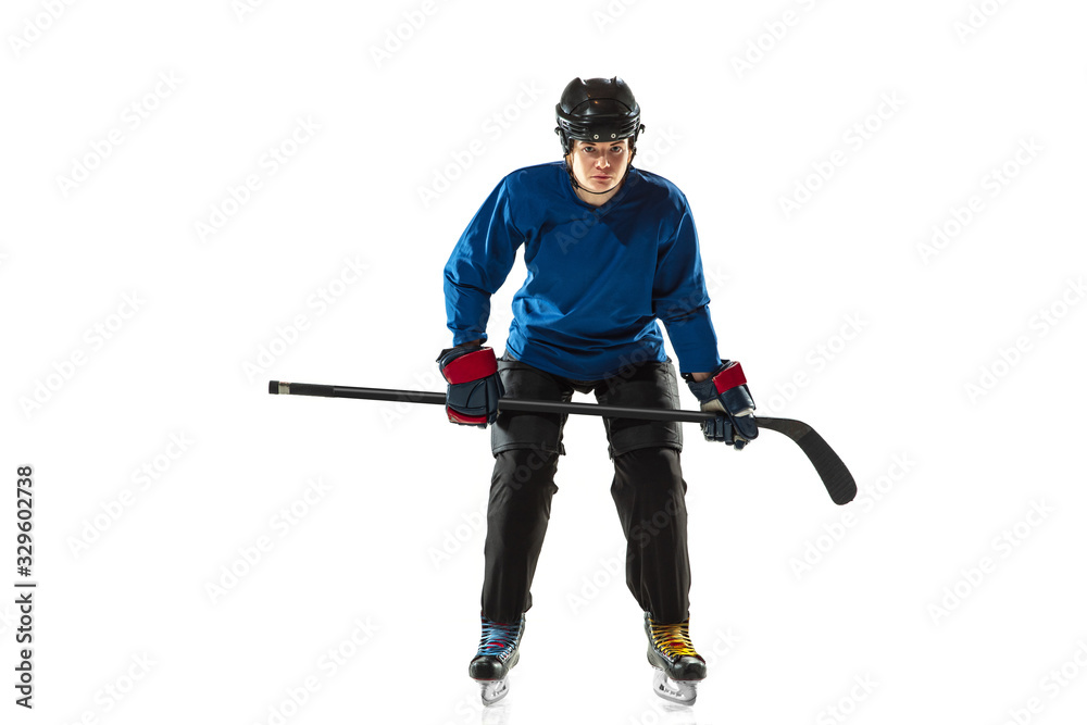 Young female hockey player with the stick on ice court and white background. Sportswoman wearing equipment and helmet training. Concept of sport, healthy lifestyle, motion, action, human emotions. Young female hockey player with the stick on ice court and white background. Sportswoman wearing equipment and helmet training. Concept of sport, healthy lifestyle, motion, action, human emotions.