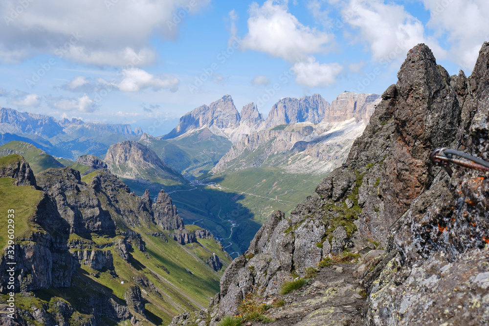 View of mountain peaks and ridges as seen from via ferrata Delle Trincee, Padon Ridge, Dolomites mountains, Italy. Concept for Summer adventure activities in nature.