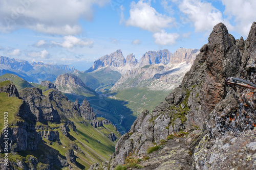View of mountain peaks and ridges as seen from via ferrata Delle Trincee, Padon Ridge, Dolomites mountains, Italy. Concept for Summer adventure activities in nature.