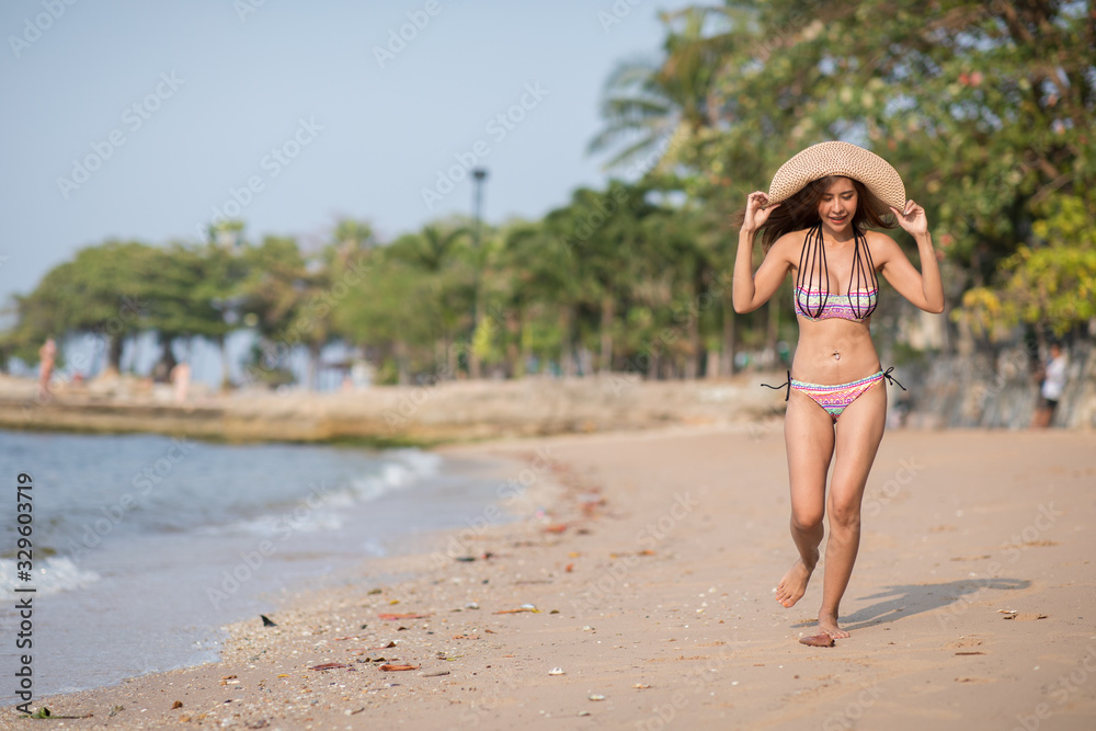 Girl wearing bikini walking on the beach