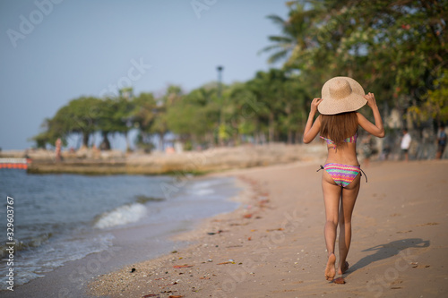 Girl wearing bikini walking on the beach