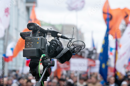 Videographer is reporting from a city street during a mass political action in Moscow, Russia. Camera is up of the crowd photo