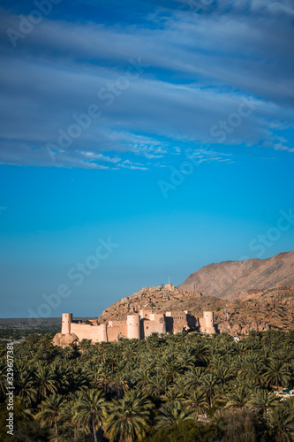 Sunset view of the Nakhal Fort surrounded by a palm grove  Oman