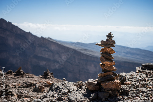 Small grouping of stones with the mountains in the background at the Grand Canyon of Jebel Shams, Oman