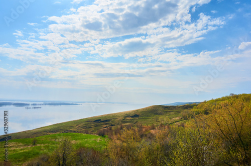 Mountain sea shore in the fall against the blue sky with clouds.