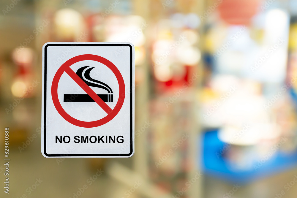No Smoking label in the public with blur nature background.