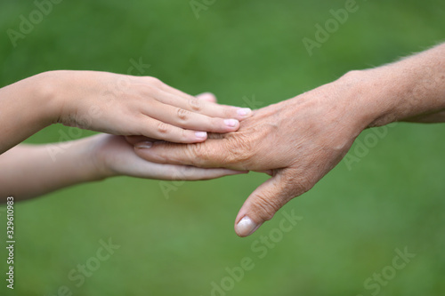 Portrait of senior woman and child holding hands © aletia2011
