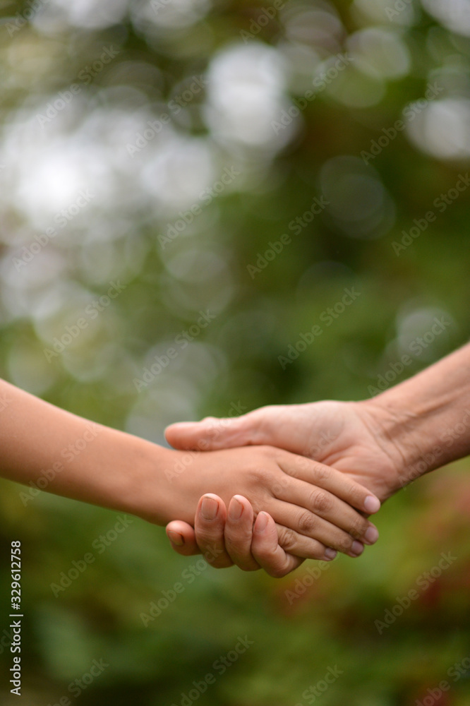 Portrait of a person holding granddaughter's hand Portrait of a person holding granddaughter's hand
