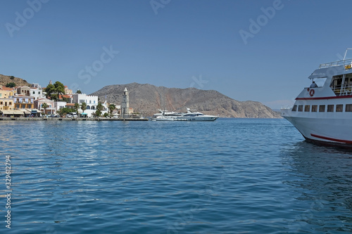 Scenic view of the sea surface of Symi island, Greece. Ships and yachts in the bay of the island on the Aegean Sea.  © Anna