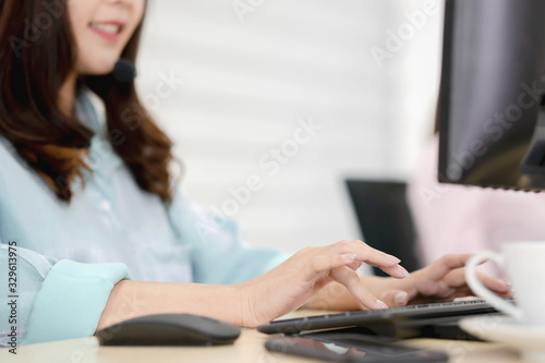 Close up shot of businesswoman hand typing and working on desktop computer on the office desk.