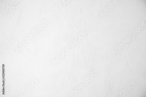 Neutral white colored low contrast Concrete textured background with roughness and irregularities to your concept or product.