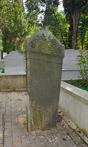 Historic grave stones with Ottoman Turkish script in Karacaahmet Cemetery in the Uskudar district of Istanbul. It is the oldest cemetery in Istanbul and the biggest burial ground in Turkey photo