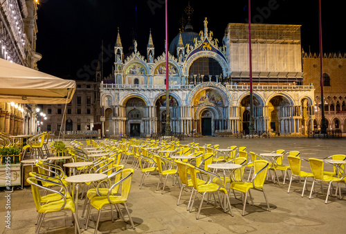 Fototapeta Naklejka Na Ścianę i Meble -  Night view of one Bar on the Piazza San Marco showing a multitude of empty chairs and empty square