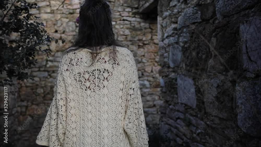 Beautiful women is walking around the ruined house. Beautiful women is walking around the ruined house.