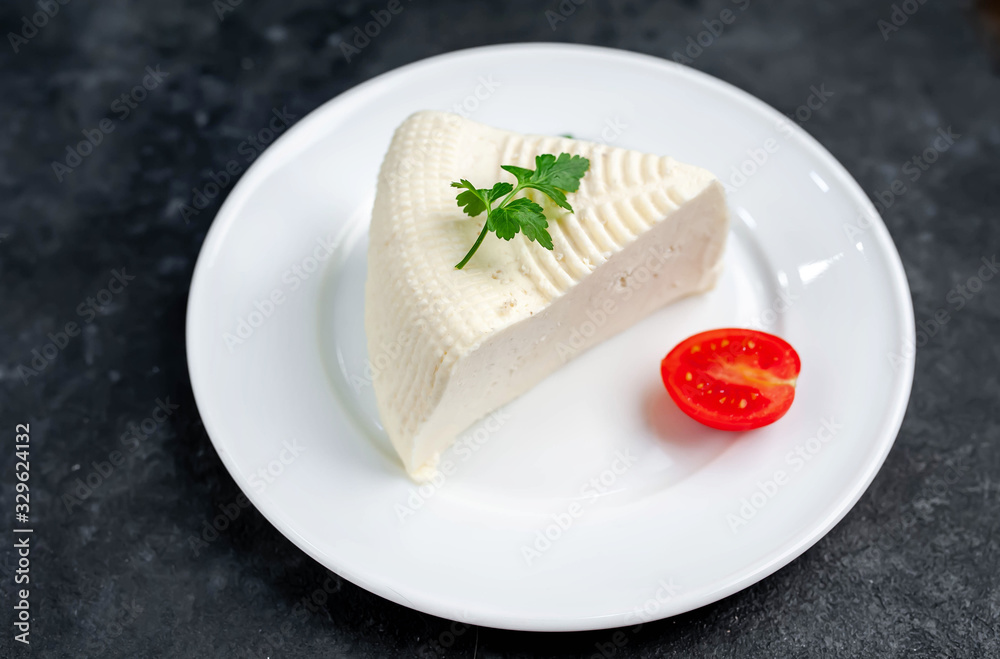 feta cheese on white  plate on stone background