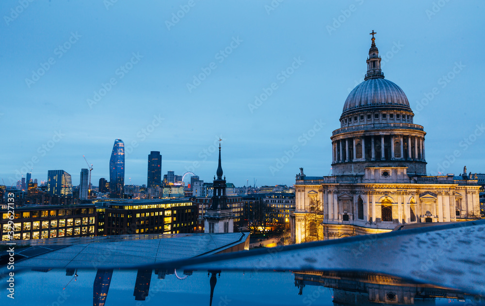 View of St. Pauls Cathedral and evening London cityscape during dusk on cloudy day