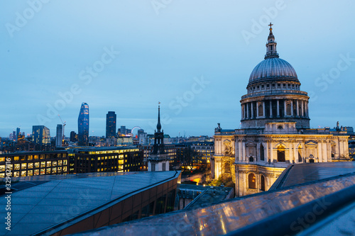 View of St. Pauls Cathedral and evening London cityscape during dusk on cloudy day photo