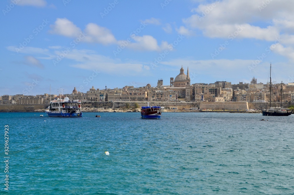 Fototapeta premium The medieval limestone city of Valletta with its main symbols - bell tower of St Paul Pro-Cathedral and large dome of Carmelite church, Malta