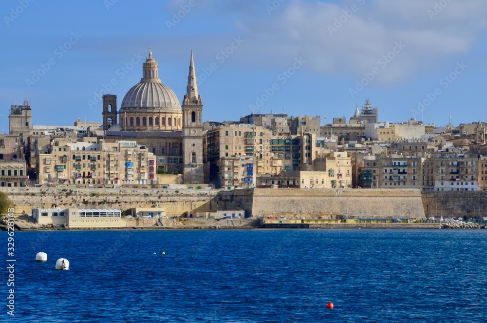 The medieval limestone city of Valletta with its main symbols - bell tower of St Paul Pro-Cathedral and large dome of Carmelite church, Malta