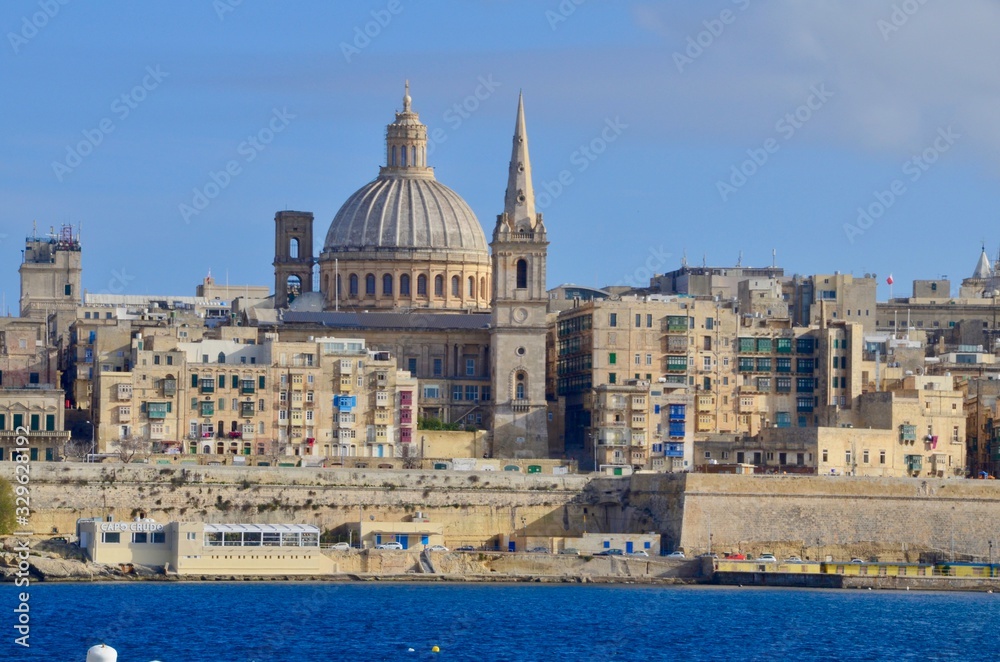 The medieval limestone city of Valletta with its main symbols - bell tower of St Paul Pro-Cathedral and large dome of Carmelite church, Malta