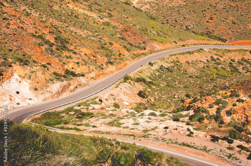 .lonely winding road between mountains in almeria spain