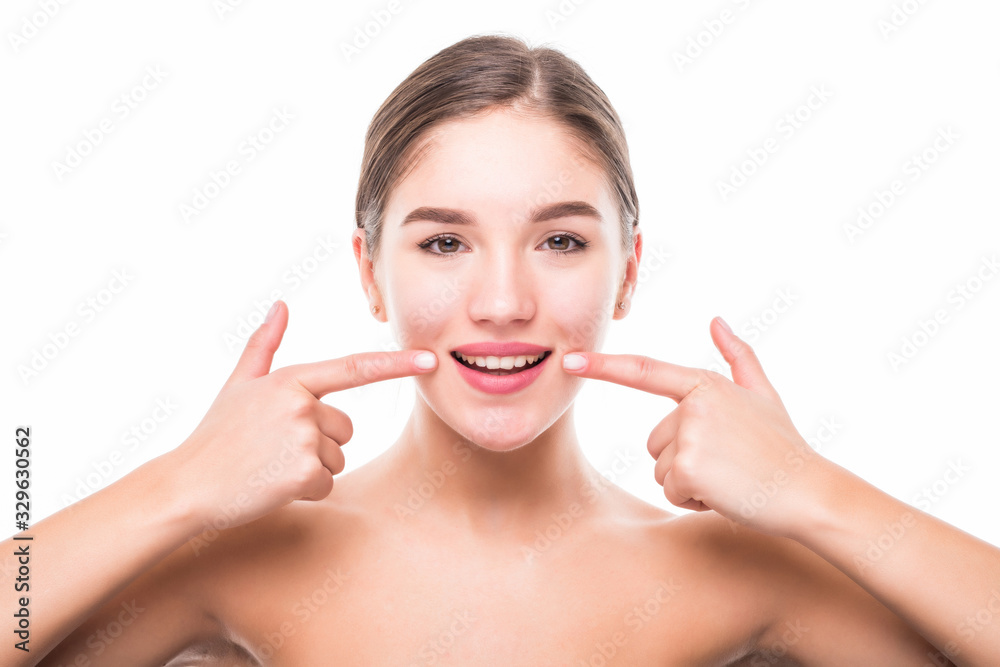 Young woman showing her perfect straight white teeth isolated on white background Young woman showing her perfect straight white teeth isolated on white background