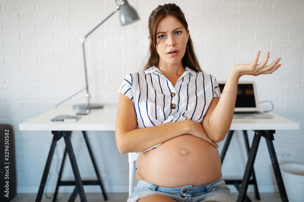 Pregnant woman working from home. Career and pregnancy concept Pregnant woman working from home. Career and pregnancy concept