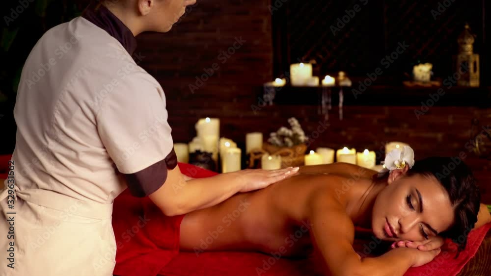 Massage in spa salon for full body with woman and masseur.