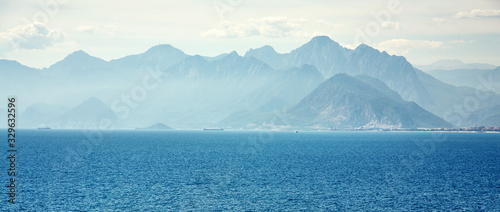 picturesque landscape with sea, mountains and clouds. blue nature of a bay.