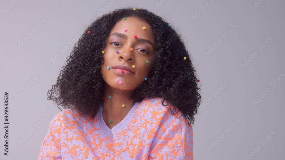 Mixed race black woman with creative avangard makeup simple colorful dot makeup on flawless skin Studio portrait new beauty panned portrait Mixed race black woman with creative avangard makeup simple colorful dot makeup on flawless skin Studio portrait new beauty panned portrait