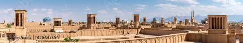 Yazd cityscape with old brick buildings and badgirs wind catching towers in Yazd, Iran. photo