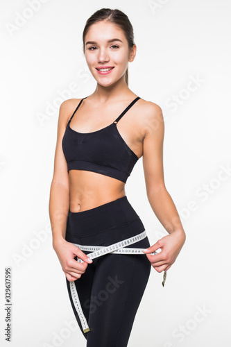 Fitness woman measuring perfect shape of beautiful hips isolated on white background. Healthy lifestyles concept © dianagrytsku