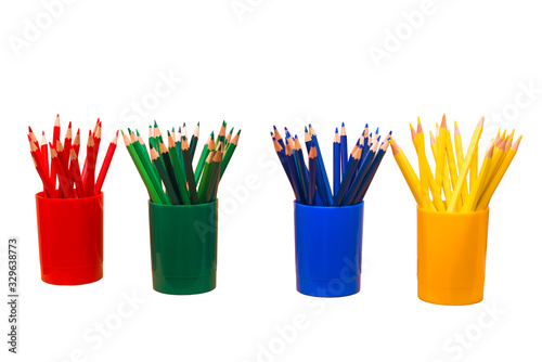 Colored pencils in colored glasses. On white background. Isolated