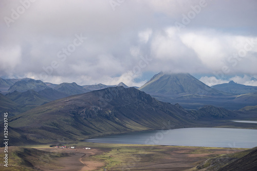 View on Hvanngil mountain hut and camp site with green hills, river stream and lake. Laugavegur hiking trail, Iceland