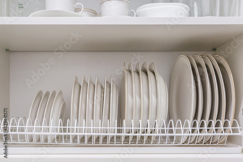 Obraz na plátně set of plates on the shelf in the kitchen cabinet