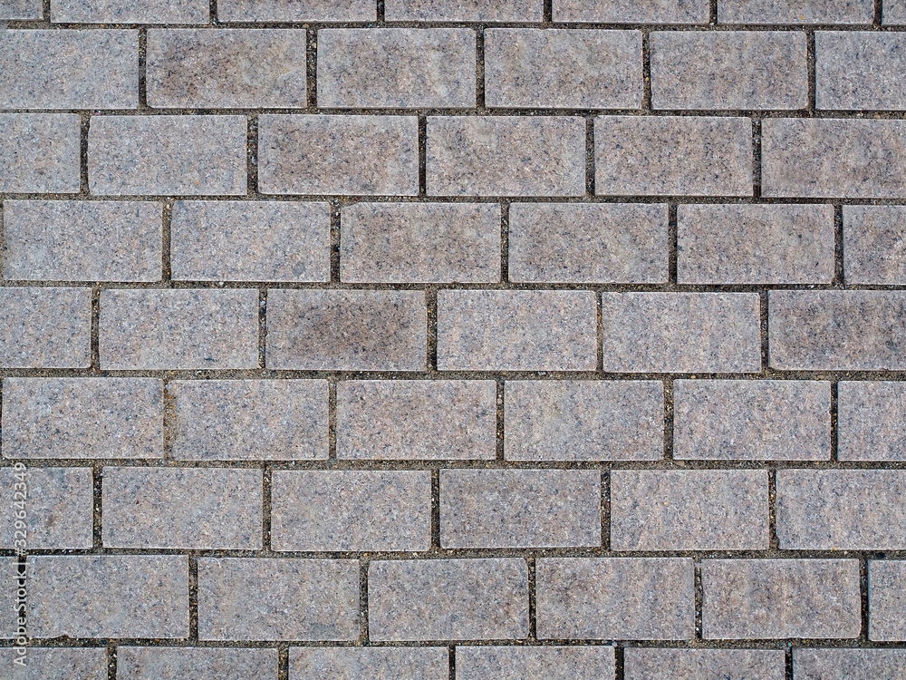 Granite cobblestoned pavement background texture.